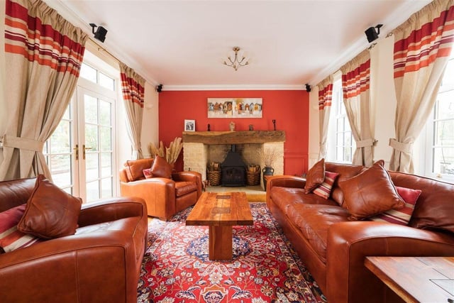 This cosy living room with its feature stone fireplace is countryside perfection.