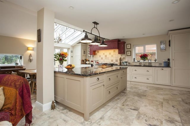 The open plan kitchen is kitchen is fitted with a range of Tom Howley inspired bespoke Shaker style units with feature vaulted ceiling with skylights adding further light