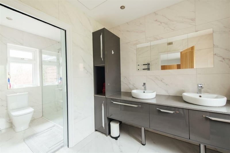 The en-suite shower room has a full length vanity unit with drawers, cupboards, quartz top with two basins, WC and walk-in shower cubicle. There is also a fully tiled floor  with balcony with glazed balustrades overlooking the rear garden.