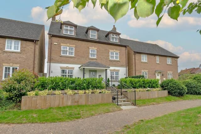 This impressive property offers spacious accommodation set across three floors with landscaped garden and double garage with parking area in the gated rear.