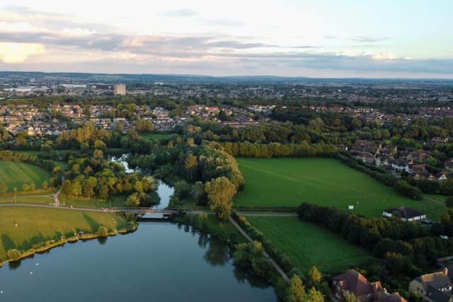 aerial view of green grass field near lake during daytime