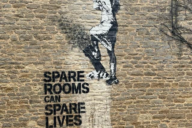 The mural on the historic Milton Keynes farmhouse states that spare rooms can spare lives