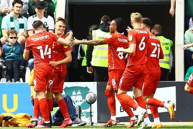 MK Dons celebrate with Scott Twine in the rampant 5-0 win at Plymouth