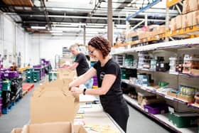 Angie Row from St Mark's Meals packing food kits.