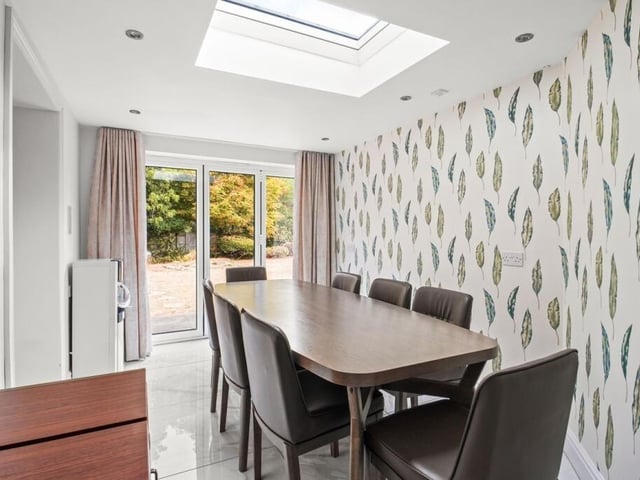 The dining room at the property is described as a natural setting for everyday meals and larger occasions, and provides access to the utility room and conservatory