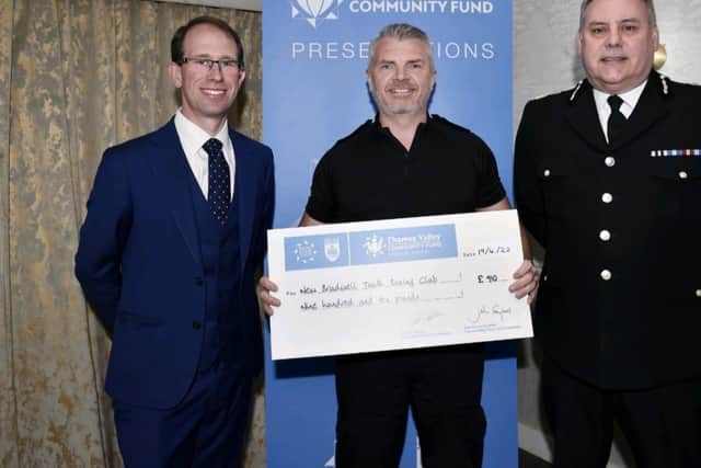 PC Cafe  receives a  cheque from the Chief Constable and Police and Crime Commissioner