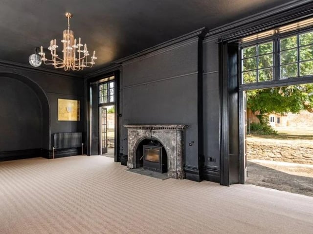 A period-style sitting room has French doors which open straight onto the garden terrace, as well as a traditional fireplace. Photo: Fisher German LLP - South/ Zoopla