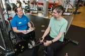An instructor looking after a customer in the gym