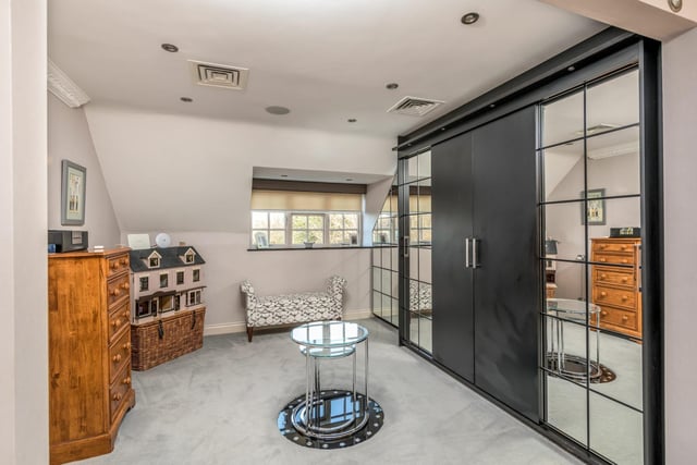 One of the property's five bedrooms features modern style mirrored fitted wardrobes.