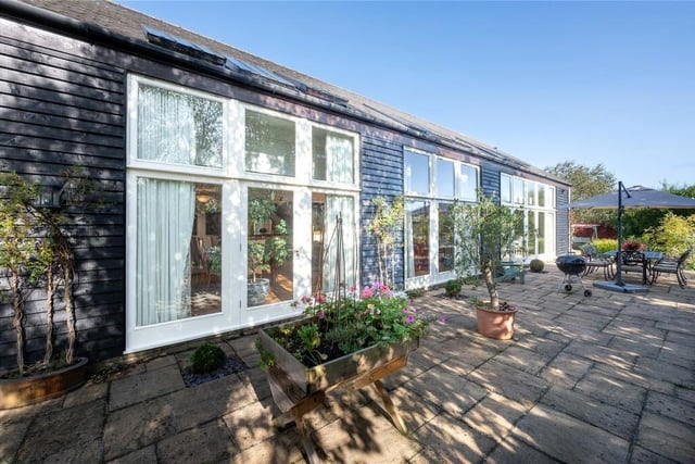 An extensive south facing stone terrace spans the full width of the barn at the front and is accessed by doors from the kitchen/breakfast/living room and the two principal reception rooms.