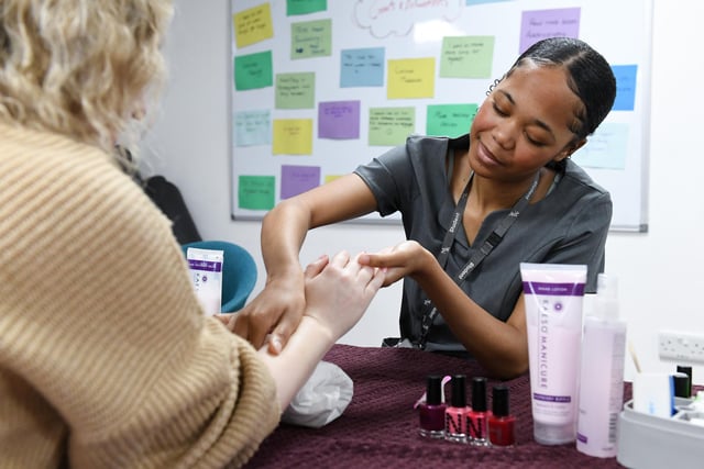 A beauty student gives a free manicure