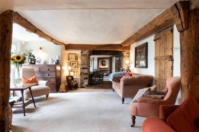 Wavendon Cottage is entered by a storm porch with clay tile roof and panelled entrance door leading to the entrance hall with brick floor and exposed ceiling beams and wall timbers
