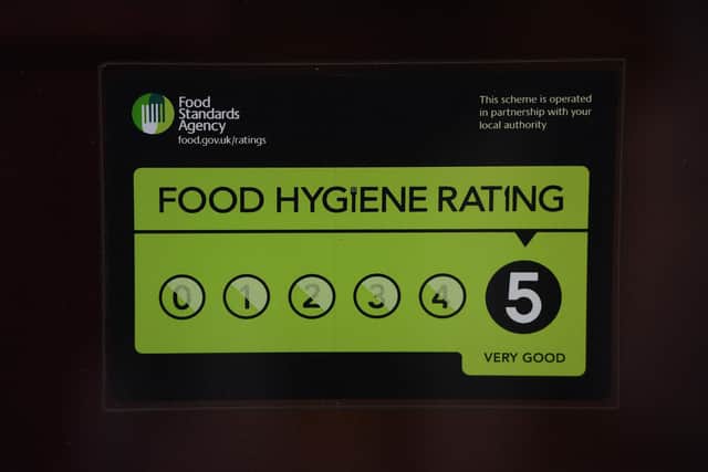 A Food Standards Agency 5 star rating sticker on a window of a restaurant