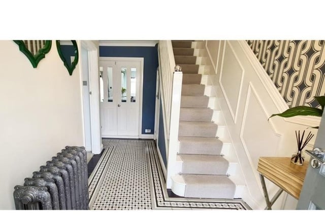 The entrance hall has been tastefully decorated with panelled walls with feature column radiator
