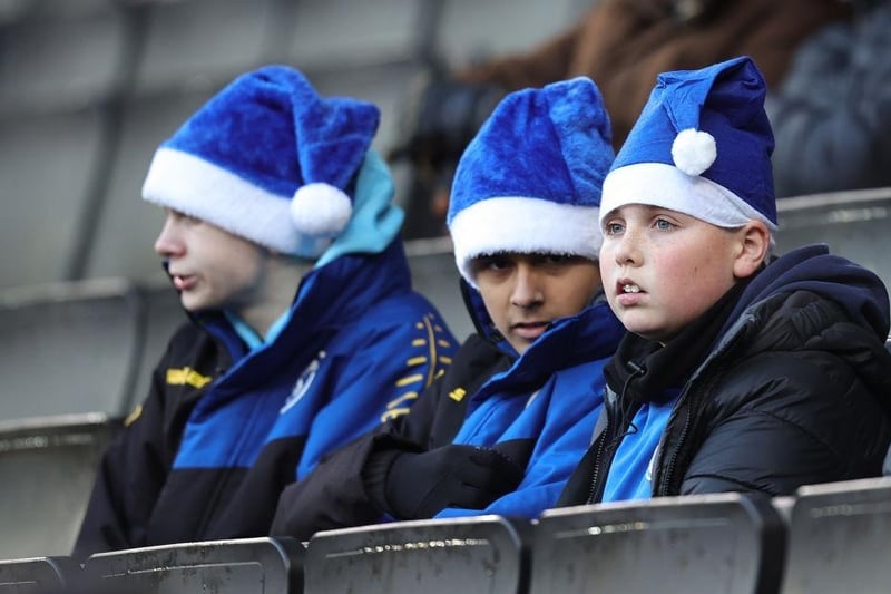Young Fans look on wearing Santa Hats prior to the Sky Bet League One between Milton Keynes Dons and Fleetwood Town at Stadium MK on December 10, 2022.