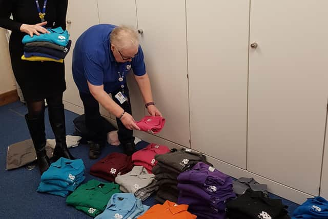 PJ Care workers Charley Neal and Judith Thomas pack the coloured shirts to send to Africa