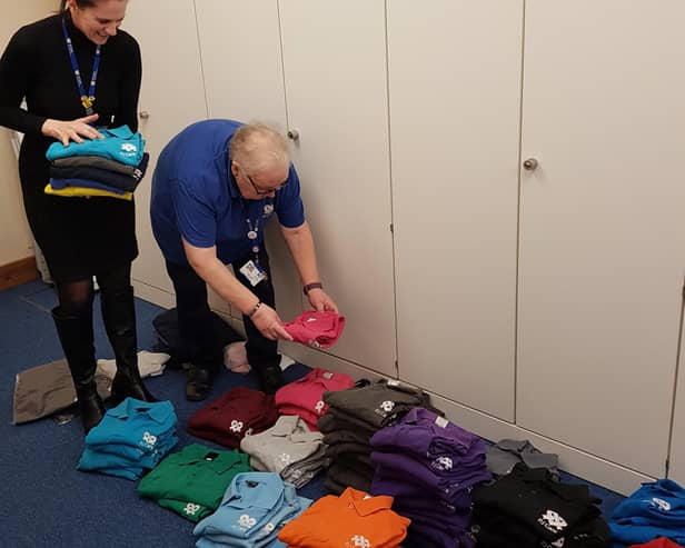 PJ Care workers Charley Neal and Judith Thomas pack the coloured shirts to send to Africa