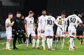 MK Dons getting some instructions pitchside during the 0-0 draw with Lincoln City