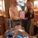 Molly receives the award from John Mclaughlin of CAMRA.
