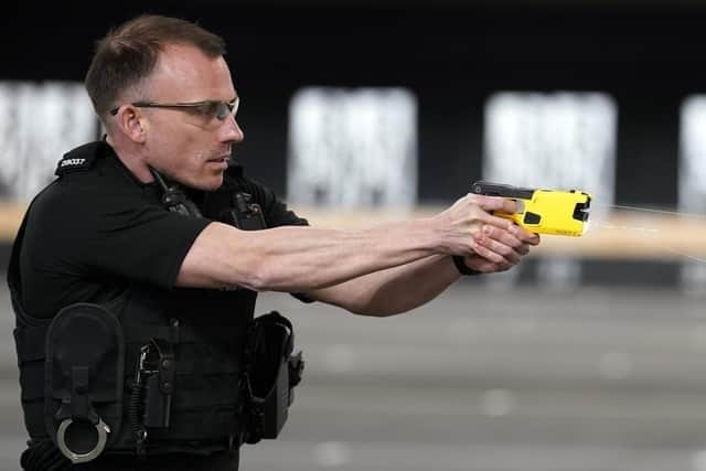 An officers tries out the new Taser 7 device