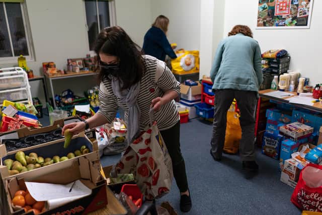 Volunteers are seen packing food parcels with food bank charity, the Trussell Trust, estimating more than 5,100 food parcels are provided to households every day.