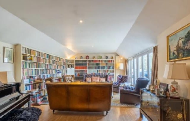 Another of the three reception rooms in the property, as well as grand furniture, this one contains a piano.