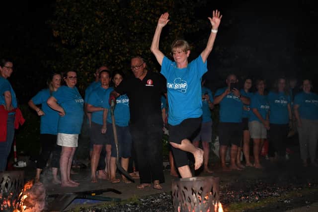 Firewalker Sue Harding braves the burning embers to help MK SNAP