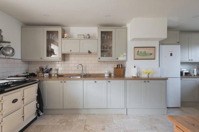 The kitchen features an electric AGA, Bosch integrated dishwasher, shaker-style painted furniture, with deep drawers and interior pull-outs