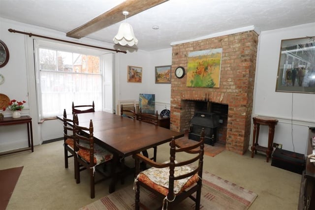 The dining room features exposed stonework with fireplace incorporating a coal effect gas fire.