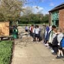 Pupils from Olney Infant School hearing about their new wildflower turf from George Davies Turf