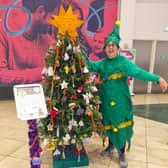 Jane Hammonds, who will be running the |MK Winter Hal Marathon dressed as a Christmas tree, is pictured alongside her Memory  Xmas Tree at Midsummer Place