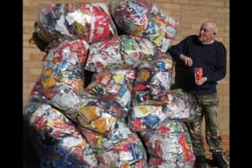 Recycling king George with his mountain of crisp packets