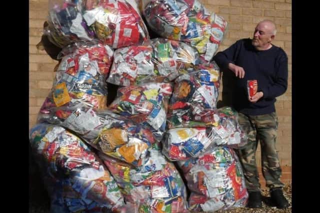 Recycling king George with his mountain of crisp packets