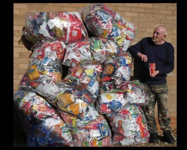 Recycling king George with his mountain of crisp packets