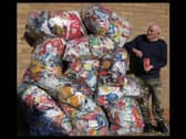 Recycling king George with his mountain of crisp packets