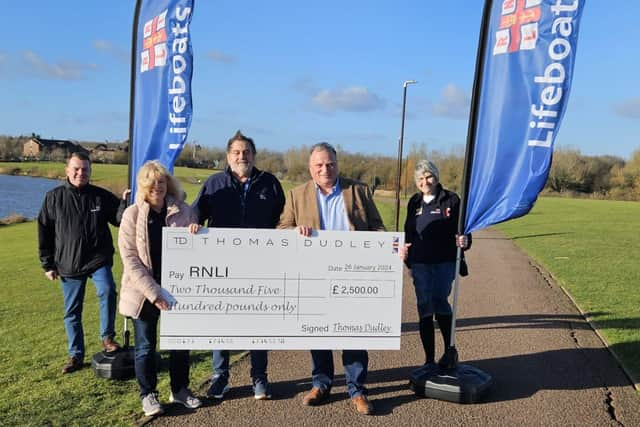 Chris Slezakowski hands the cheque to Mike McMahon of the RNLI