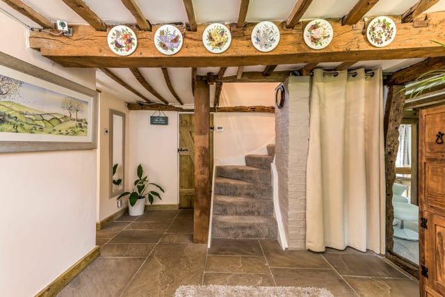 The entrance hall has a feature stable door, with flagstone floors, beams and understairs storage.