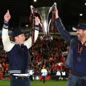 Hollywood stars Rob McElhenney and Ryan Reynolds, the owners of Wrexham celebrate with the Vanarama National League trophy in Apairl. MK Dons will start the new sky Bert League Two season at the Racecourse Ground (Picture: Jan Kruger/Getty Images)