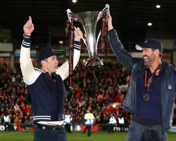 Hollywood stars Rob McElhenney and Ryan Reynolds, the owners of Wrexham celebrate with the Vanarama National League trophy in Apairl. MK Dons will start the new sky Bert League Two season at the Racecourse Ground (Picture: Jan Kruger/Getty Images)