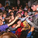 Children crowd round the alien that landed at their MK school in 1988