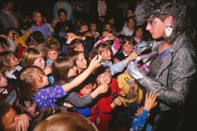 Children crowd round the alien that landed at their MK school in 1988