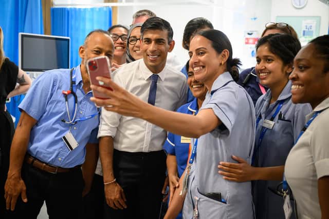 MILTON KEYNES, ENGLAND - AUGUST 15: Prime Minister Rishi Sunak poses with members of staff in the SDEC (same day emergency care unit) during a visit to Milton Keynes University Hospital on August 15, 2023 in Milton Keynes, England.  (Photo by Leon Neal - WPA Pool/Getty Images)