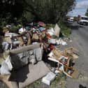 Fly-tipped rubbish and waste is seen beside a road in Colnbrook, near Heathrow, west of London on May 11 2020.
