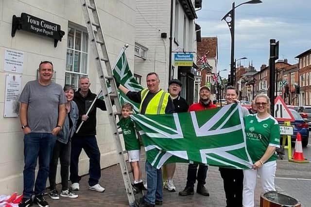 The town was bedecked with green and white flags