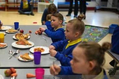 Children enjoy their free breakfast at school