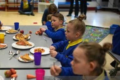 Children enjoy their free breakfast at school