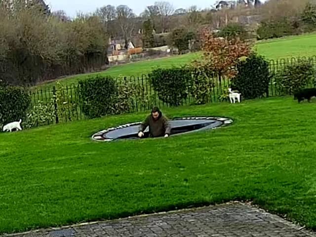 Charlie Bond hits the water after plummeting through the trampoline