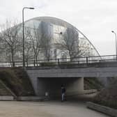 MILTON KEYNES, ENGLAND - JANUARY 23:  A woman walks through an underpass near the Xscape centre and snowdome on January 23, 2017 in Milton Keynes, England. Milton Keynes in Buckinghamshire marks the 50th anniversary of its designation as a new town today. The town is home to around 25,000 people and approximately 130 roundabouts. It was designed by British architect and planner Derek Walker.  (Photo by Dan Kitwood/Getty Images)