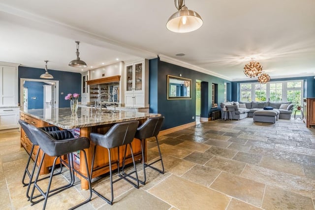 The contemporary kitchen features a sizeable breakfast bar with extra storage space,