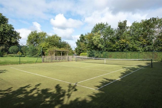 The 1.1 acre garden includes a a timber stable block and lying behind is a further area of lawn and Astroturf tennis court.